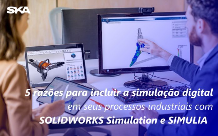 casal de engenheiros utilizando software de simulação digital no computador e tablet